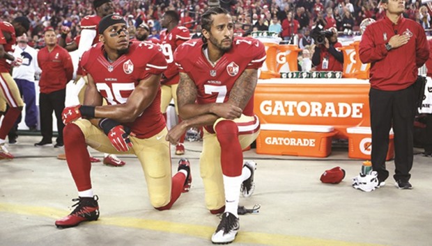 Eric Reid and Colin Kaepernick (right) take a knee during the national anthem before their game against the Los Angeles Rams recently. (AFP)