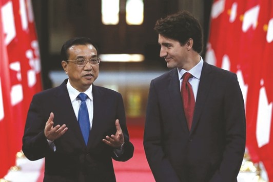 Canadau2019s Prime Minister Justin Trudeau (right) and Chinese Premier Li Keqiang attend a signing ceremony in the Hall of Honour on Parliament Hill in Ottawa yesterday. Li and Trudeau said the trade and extradition treaty talks were part of an attempt to improve the relationship between the two countries.