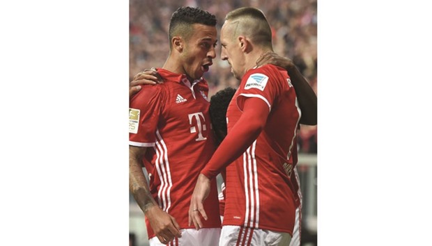 Bayern Munichu2019s Thiago Alcantara (left) and Franck Ribery celebrate after their teamu2019s opening goal during the Bundesliga match against Hertha Berlin in Munich on Wednesday. (AFP)