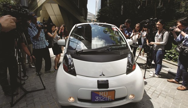 Media personnel crowd around a driverless car in Singapore. Southeast Asiau2019s leading ride-hailing firm Grab yesterday teamed up with a US-based software developer to run a limited public trial of a self-driving car service in Singapore.