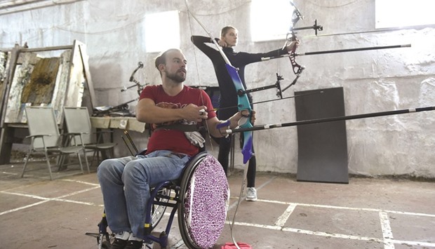 Ukrainian Paralympics archer Dmytro Schebetyuk (L), takes part in a training.