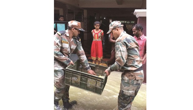 Soldiers distribute food packets to flood victims in Hyderabad yesterday.