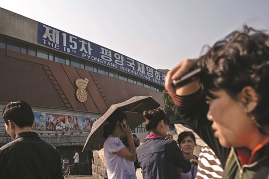 This picture taken on Friday shows people arriving to watch a film at the Pyongyang International Cinema during the PIFF.