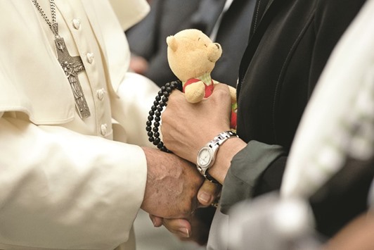 This handout picture released by the Vatican press office yesterday shows Pope Francis holding a womanu2019s hand during an audience with survivors and relatives of the victims of the July 14 Nice attack, in the Paul VI hall at the Vatican.