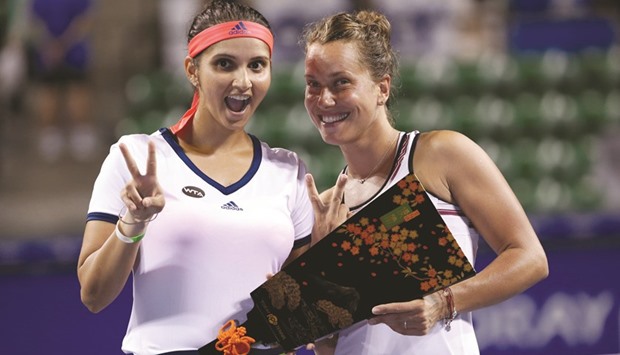 Sania Mirza of India (L) and Barbora Strycova of Czech Republic pose with their trophy. (Reuters)