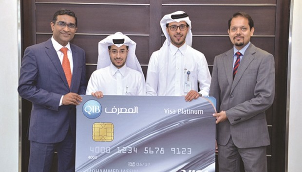 QIB and Visa  officials with the banku2019s new credit card.