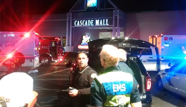 Medics wait to gain access to the Cascade Mall after shooting