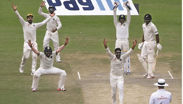 Indiau2019s Ravindra Jadeja (centre) appeals successfully with teammates for the wicket of New Zealandu2019s Ish Sodhi during the third day of the first Test at Green Park Stadium in Kanpur yesterday. (AFP)