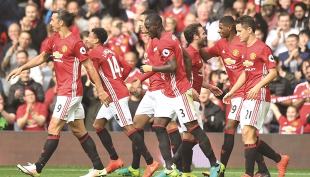 Manchester United players celebrate a goal against Leicester City in their Premier League clash yesterday. (AFP)