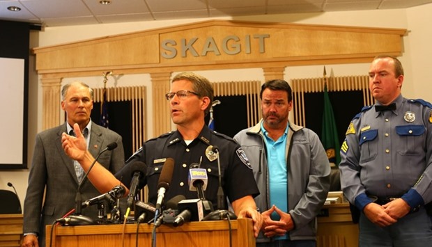Governor Jay Inslee (L) of Washington State, Mayor Steve Sexton (2nd-R) of Burlington and Patrol officer Keith Leary (R) of Washington State listen as Lt. Christopher Cammock of the Mount Vernon Police Department speaks at a press conference on September 24, 2016 in Burlington, Washington.