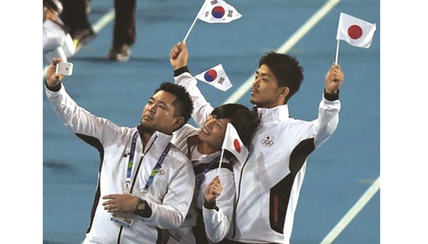 Japan will host the 2026 Asian Games, adding to its already bulging international sports calendar as it also gears up to host the 2020 Summer Olympics. This file photo shows Japanese athletes taking a u2018selfieu2019 as they parade during the closing ceremony of the 2014 Asiad in Incheon. (AFP)