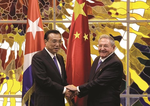 Cubau2019s President Raul Castro shakes hands with Chinese Premier Li Keqiang during their meeting at Havanau2019s Revolution Palace, Cuba.