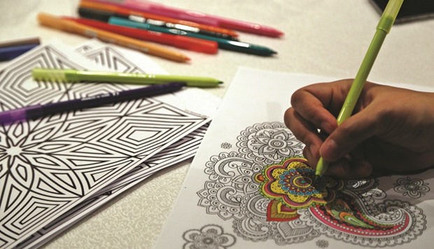 A participant uses artistic flair to colour a pattern.