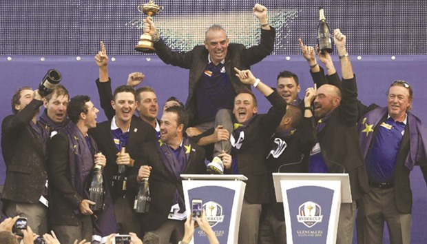 In this September 28, 2014, picture, Europe captain Paul McGinley (back) celebrates with players after his teamu2019s Ryder Cup triumph at Gleneagles in Scotland. Holders Europe have won three consecutive Ryder Cups, and eight of the last 10.