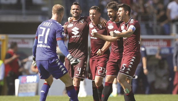 Torino players celebrate after their win over AS Roma in the Italian Serie A Roma at the u2018Grande Torinou2019 stadium in Turin yesterday. (AFP)