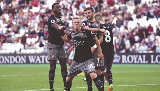 Southamptonu2019s midfielder James Ward-Prowse (centre) celebrates with teammates after scoring a goal during the English Premier League match against West Ham United at The London Stadium, yesterday. (AFP)