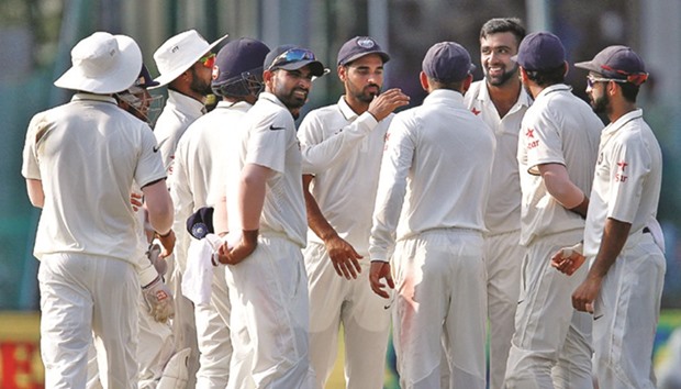 Indiau2019s Ravichandran Ashwin celebrates with teammates after taking the wicket of New Zealandu2019s Kane Williamson yesterday.