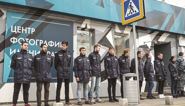 Activists in matching uniform jackets and camouflage from a little-known non-governmental organisation called u2018Officers of Russiau2019 stand outside the doors of the Lumiere Brothers Gallery, close to the Kremlin, in Moscow.