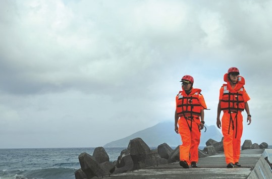 Taiwan coast guard personnel patrol the Wushih harbour at Yilan county, eastern Taiwan, as Typhoon Megi approaches.