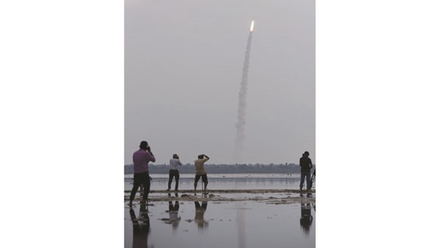 People photograph the launch of the Indian Space Research Organisation (ISRO) Polar Satellite Launch Vehicle (PSLV-C35), carrying equipment which will be used to monitor oceans and weather at Sriharikota yesterday. The rocket also deployed satellites from Algeria, Canada and the US.