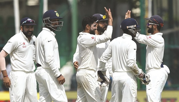 Indiau2019s Ravindra Jadeja (centre) celebrates the wicket of New Zealandu2019s Luke Ronchi with teammates on Day Five of the first Test at Green Park Stadium in Kanpur, India, yesterday. (AFP)