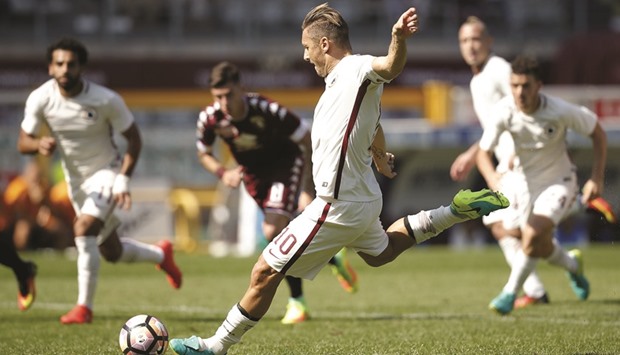 AS Romau2019s forward Francesco Totti scores a penalty during the Italian Serie A match against Torino at the u2018Grande Torinou2019 Stadium in Turin on Sunday. (AFP)s