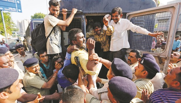 Demonstrators shout slogans as they are detained by police during a protest organised by the Dalits against what they say are increasing atrocities against their community in Ahmedabad yesterday.