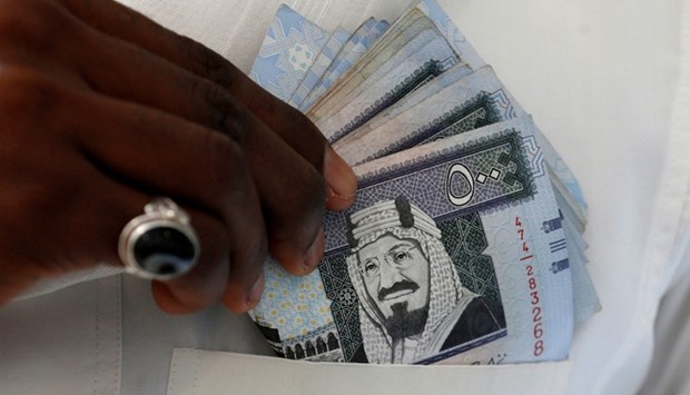 Saudi riyal banknotes are seen at a money exchange in Riyadh.