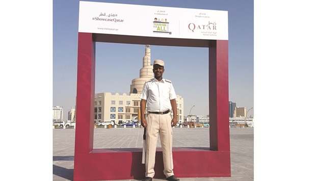 A participant poses for a picture in front of the life-size photo frame installed at Souq Waqif. PICTURE: Joey Aguilar