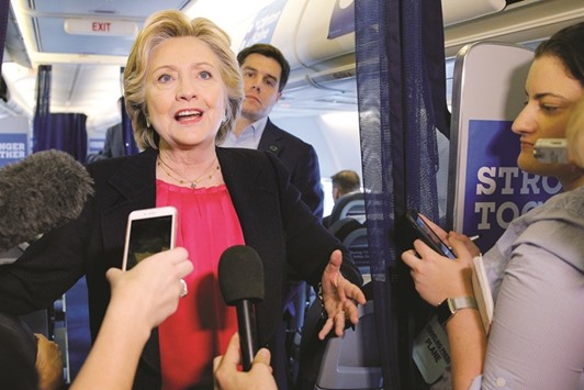 Hillary Clinton talks to reporters on her campaign plane in White Plains, New York, yesterday.