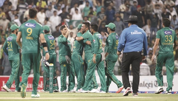 Pakistani player celebrate a wicket during the 3rd T20I match against West Indies at the Sheikh Zayed Cricket Stadium in Abu Dhabi yesterday. (AFP)