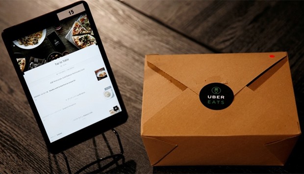 UberEats' application on a tablet and its food delivery box