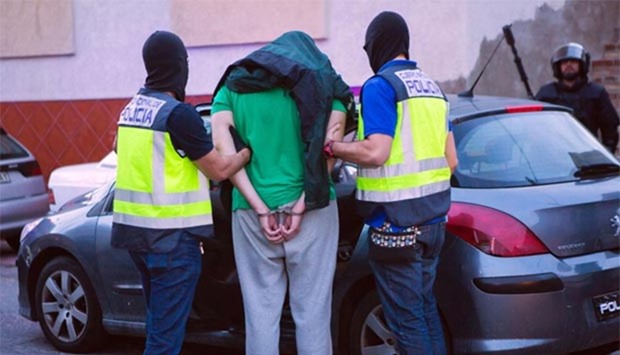 A person is taken to a police car after being arrested by Spanish police in Melilla during an international operation against jihadism on Wednesday.