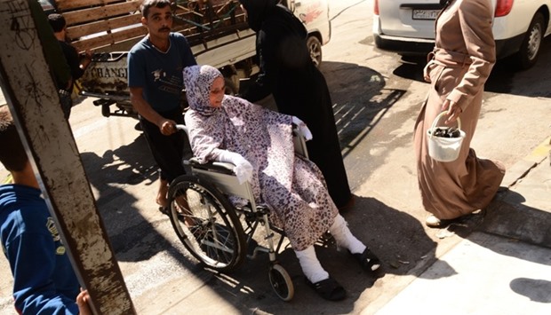 A wounded Syrian woman is wheeled into a hospital after she was hit by mortar shells that targeted Aleppo's government controlled Aziziyah and Suleimaniyah neighbourhoods. AFP