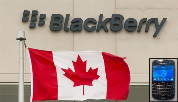 A Blackberry logo hangs behind a Canadian flag at their offices in Waterloo, Canada. Inset, a BlackBerry smartphone.