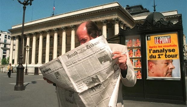 A man reading the International Herald Tribune in Paris in this file photo.