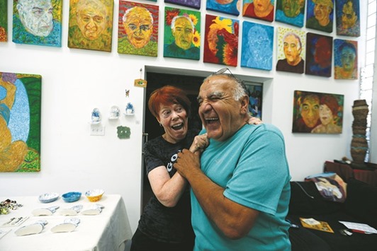 Artists Gonzalo Duran and his wife Cheri Pann in the studio of their Mosaic Tile House.