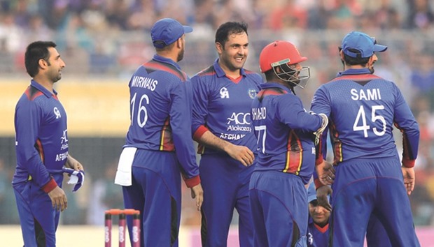 Afghanistanu2019s Mohamed Nabi (third left) is congratulated by teammates after he dismissed Bangladeshu2019s Shakib Al Hasan during the second ODI in Dhaka yesterday. (AFP)