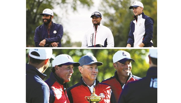 Vice-captain Tiger Woods of the United States speaks to Jordan Spieth during practice prior to the 2016 Ryder Cup at Hazeltine National Golf Club in Chaska, Minnesota, yesterday. (Below) Captain Davis Love III (centre) of the United States holds the Ryder Cup during team photocalls. (AFP)