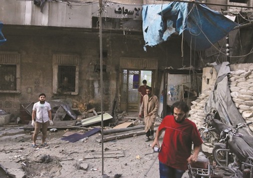 Medics inspect the damage outside a field hospital after an airstrike in the rebel-held al-Maadi neighbourhood of Aleppo.