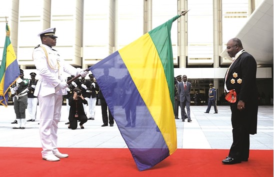 Gabon President Ali Bongo Ondimba salutes the national flag after the swearing in ceremony in Libreville on Tuesday.