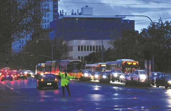 Police direct traffic in the central business district (CBD) of Adelaide after severe storms and thousands of lightning strikes knocked out power to the entire state of South Australia yesterday.