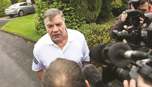 Former England national football team manager Sam Allardyce speaks to the press outside his home in Bolton yesterday.