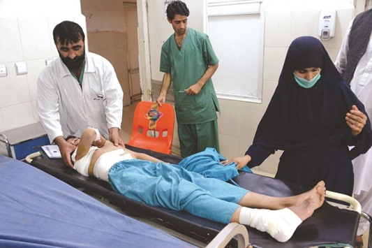 An injured Afghan youth receives treatment at a hospital following a suspected US drone air strike in the Achin district of Nangarhar province yesterday.