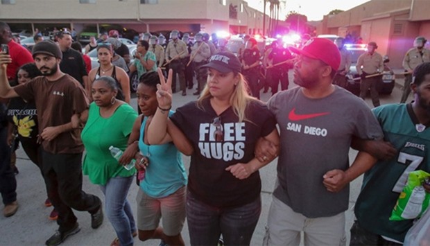 Protesters march through the street during a rally in El Cajon, a suburb of San Diego