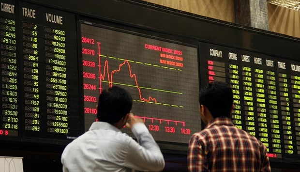 Brokers look at digital screen during bearish trend at a Stock Exchange