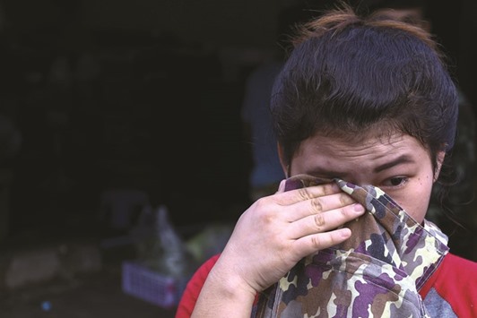 A migrant worker cries during a crack down on illegal migrant workers at a market in Bangkok yesterday.
