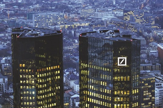 The headquarters of Germanyu2019s Deutsche Bank is photographed early evening in Frankfurt. With Deutsche Bank and Volkswagen facing multi-billion-dollar bills in the US for bad behaviour, they risk undermining an economy that is one of the few centres of global growth. The transatlantic tussles also coincide with Chancellor Angela Merkelu2019s dimmed political fortunes.
