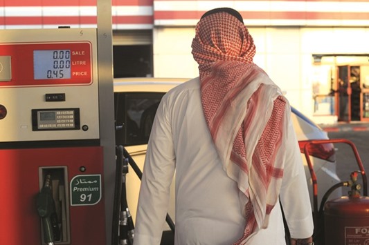 A Saudi man walks past a pump at a petrol station in the Red Sea city of Jeddah (file). The government said it would base salary payments on the Western calendar rather than the Islamic calendar; since the latter is about 11 days shorter.