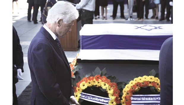 Former US president Bill Clinton pays his respects in front of the coffin of former Israeli president Shimon Peres outside the Knesset in Jerusalem.